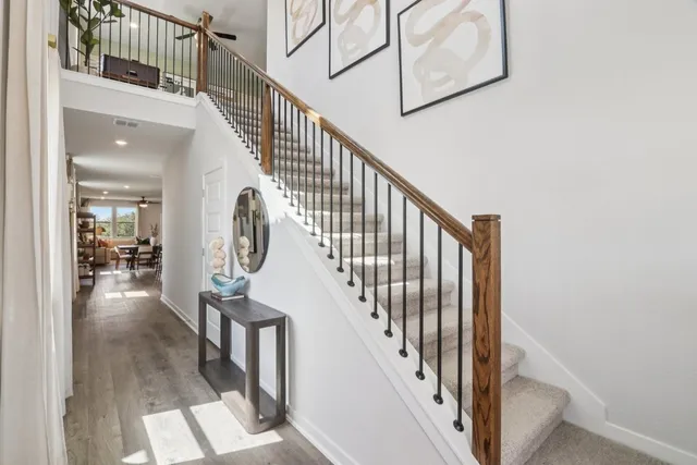 a view of entryway and hall with wooden floor
