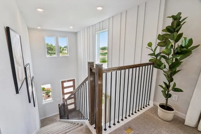a view of a hallway with windows and stairs