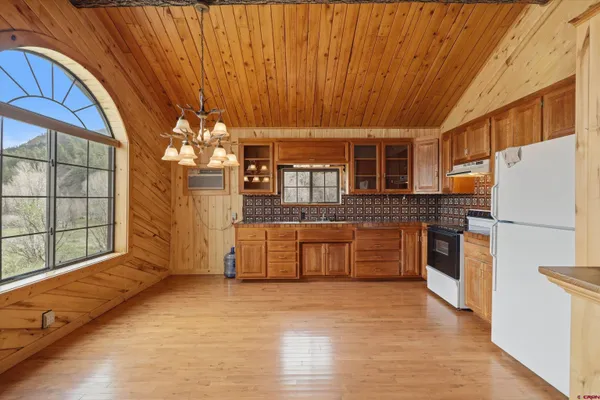a kitchen with cabinets and wooden floor
