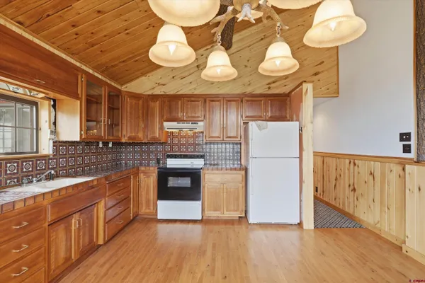 a view of a kitchen with a sink and cabinets