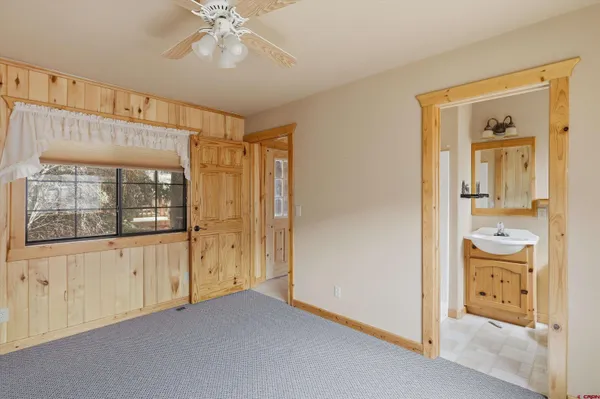 a view of an empty room with window and bathroom