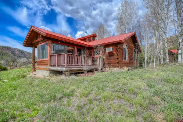 a backyard of a house with wooden fence and deck