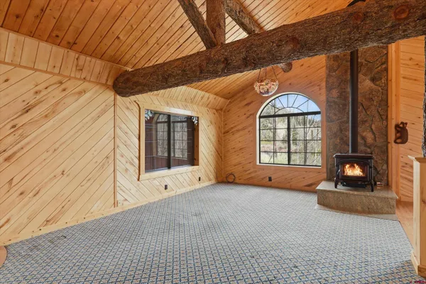 a view of an empty room with a fireplace and a window