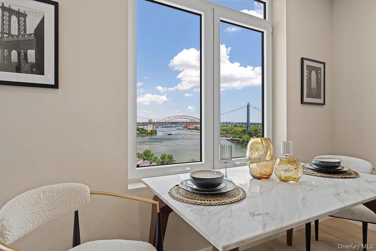 26-15 4th Street, Unit 3D Queens, NY 11102 - Photo 3 of 9 Dining area featuring a water view and wood finished floors