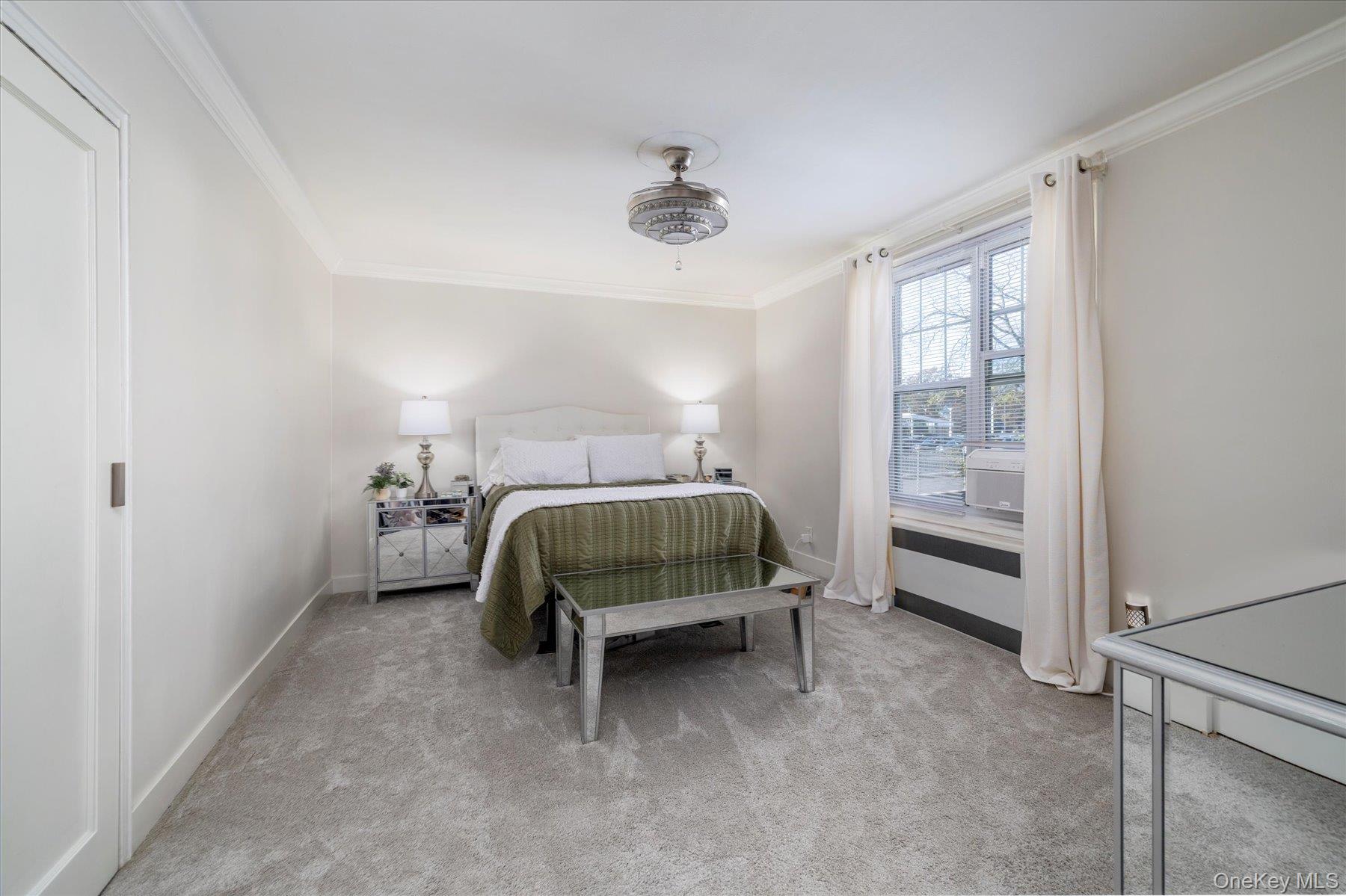 194 Smith Street, Unit 1K Freeport, NY 11520 - Photo 16 of 18 a bedroom with a bed and a window