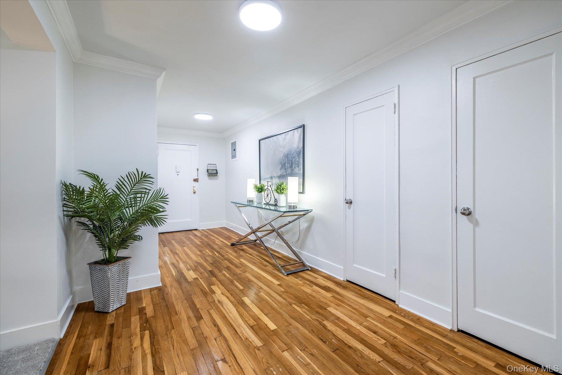 194 Smith Street, Unit 1K Freeport, NY 11520 - Photo 6 of 18 a bedroom with a bed and a potted plant