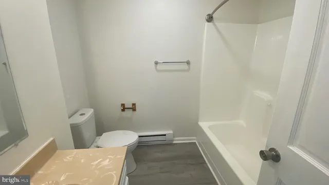 a bathroom with a toilet and shower