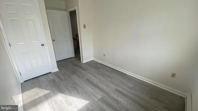 an empty room with wooden floor