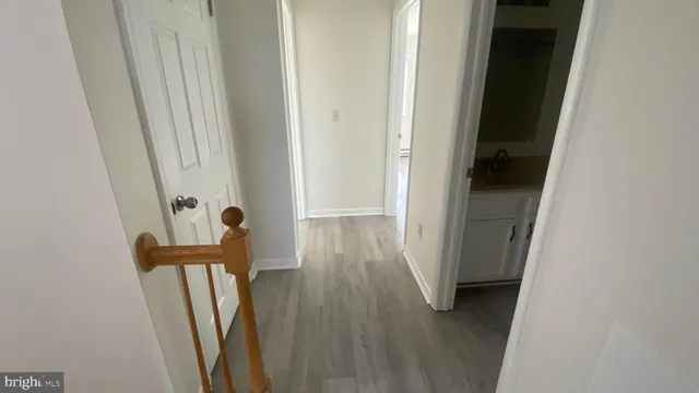 a view of hallway with wooden floor