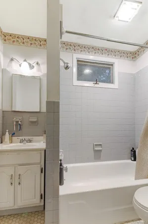 a bathroom with a sink a mirror and a bathtub