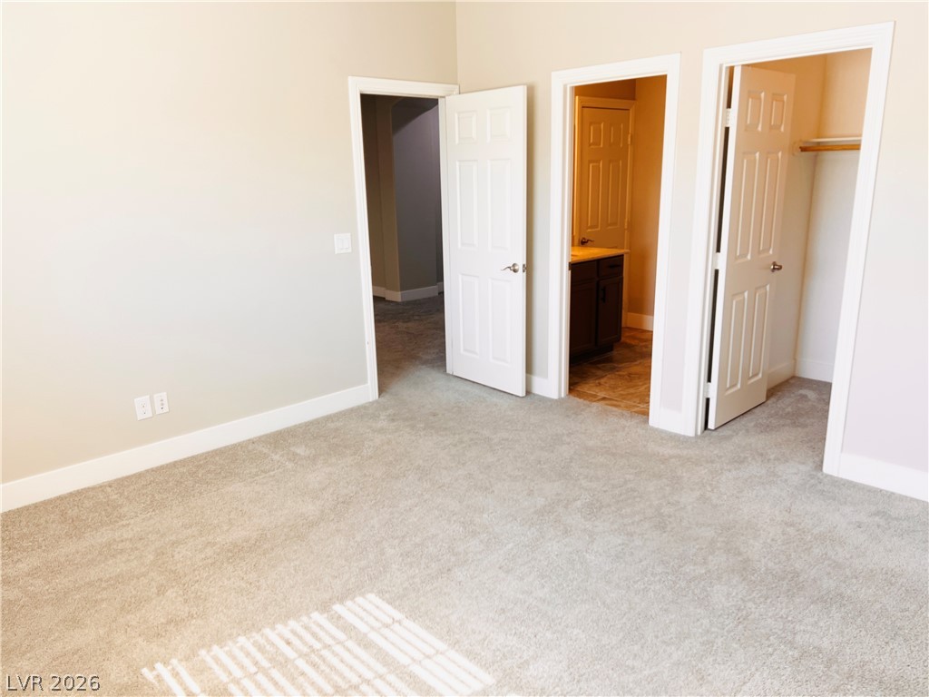 161 Dunblane Street Henderson, NV 89012 - Photo 35 of 56 An inviting bedroom offers soft carpeting and convenient access to a private bath and closet.