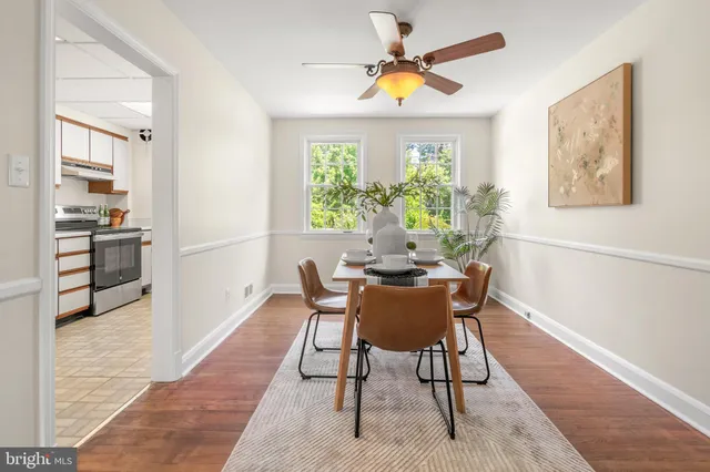 a dining room with furniture and a window