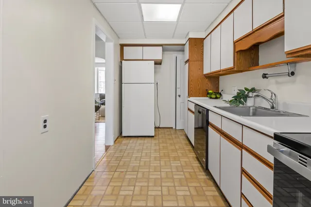 a kitchen with stainless steel appliances granite countertop a refrigerator and a stove