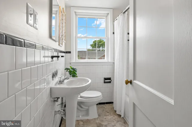 a kitchen with stainless steel appliances a sink a refrigerator and cabinets
