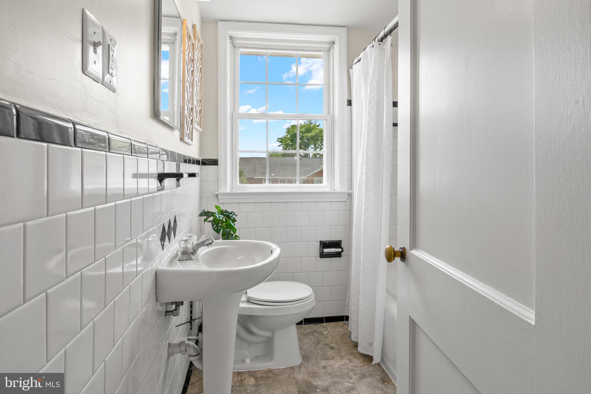 1644 Thetford Road Towson, MD 21286 - Photo 19 of 40 a bathroom with a sink a toilet a window and shower