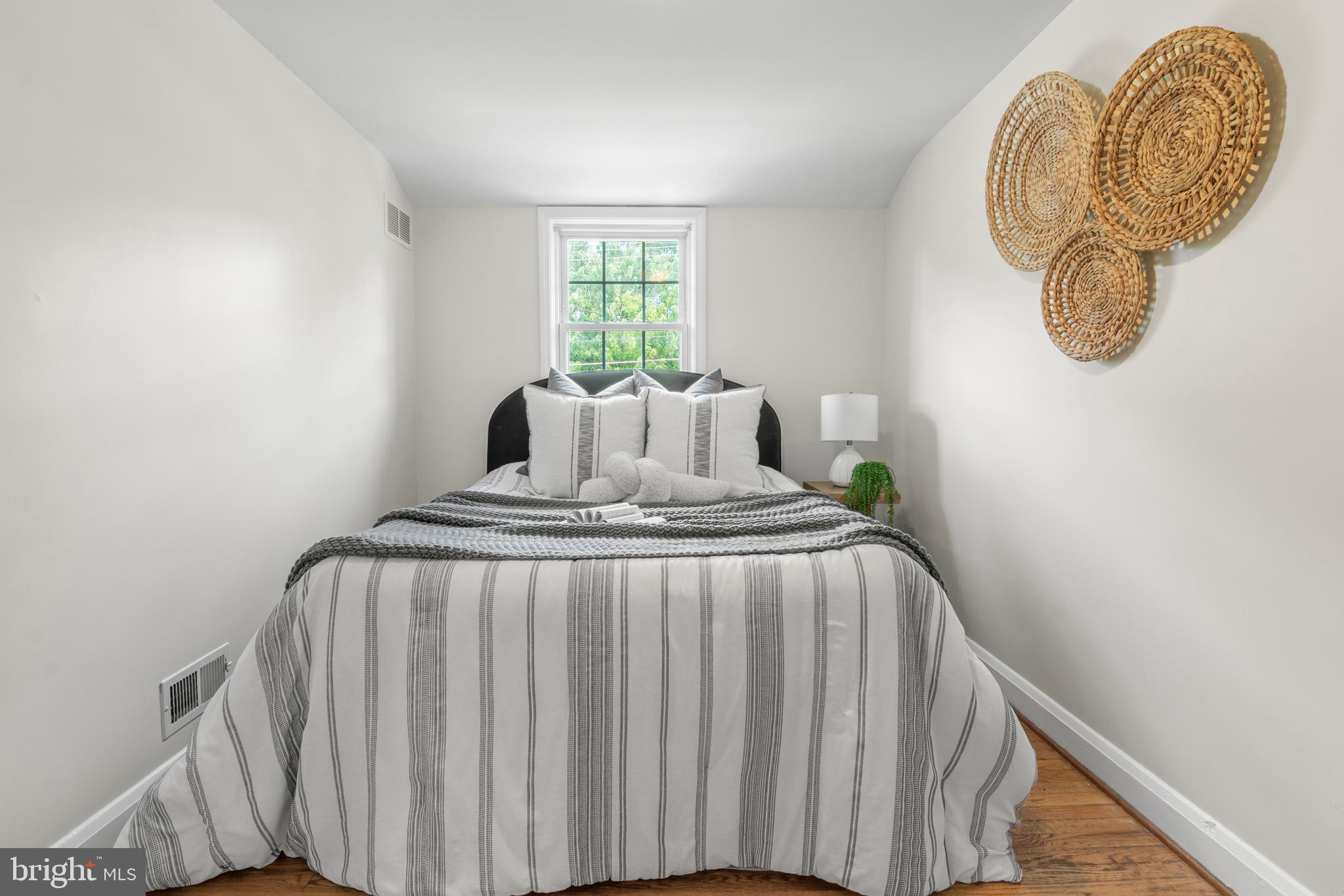 1644 Thetford Road Towson, MD 21286 - Photo 23 of 40 a bed sitting in a bedroom next to a window