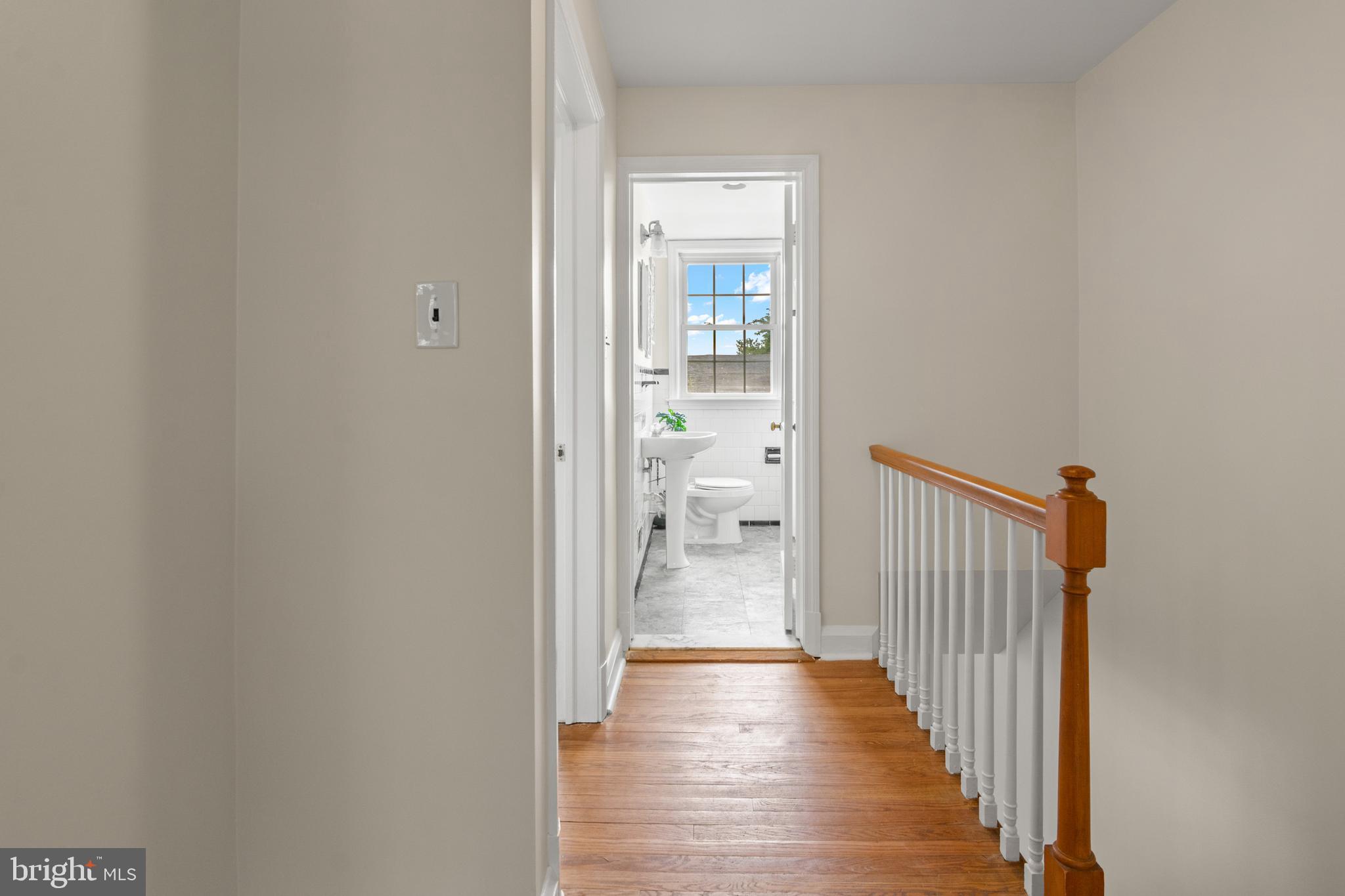 1644 Thetford Road Towson, MD 21286 - Photo 27 of 40 a view of a hallway with wooden floor and a bathroom