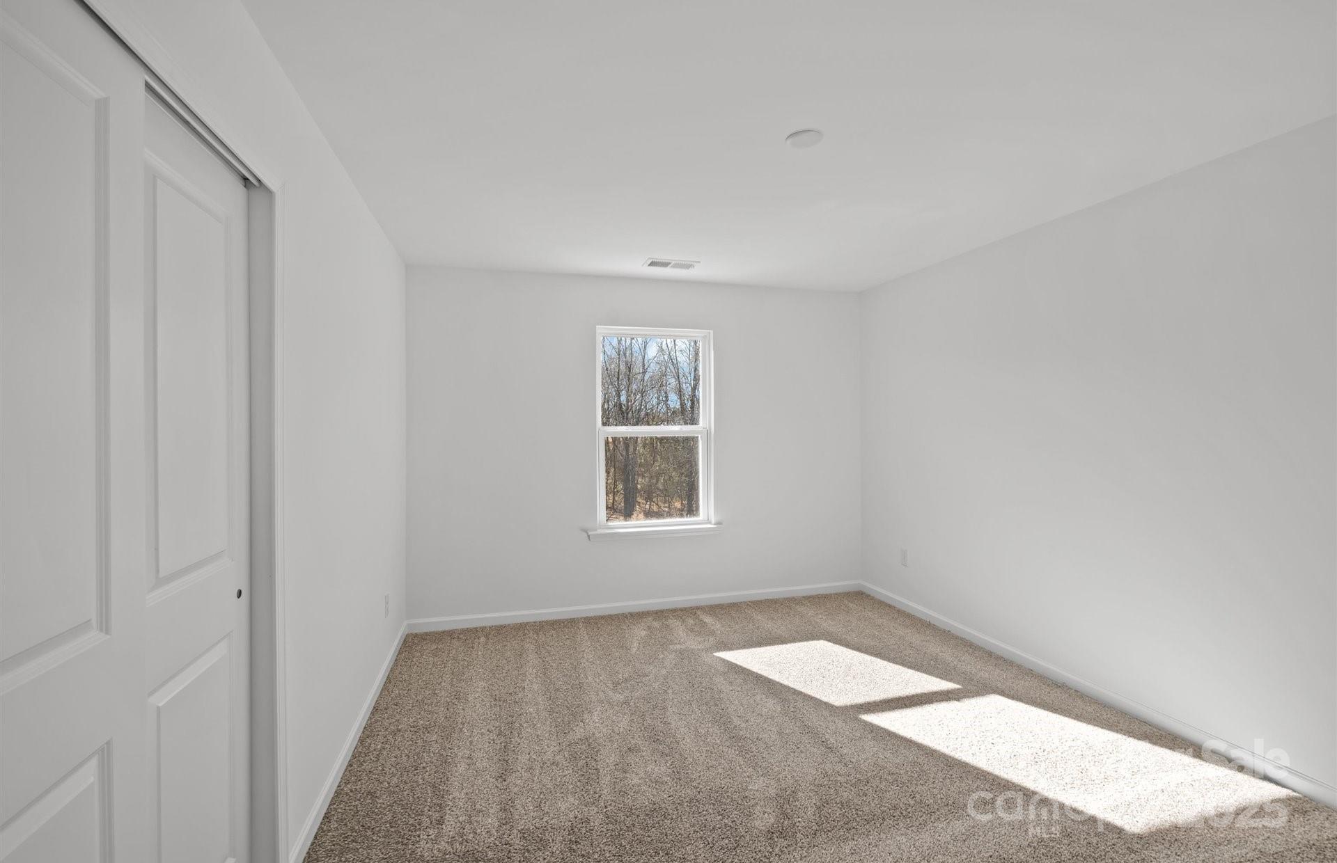 11416 Glasden Road, Unit 511 Charlotte, NC 28278 - Photo 12 of 13 a view of empty room with wooden floor and fan