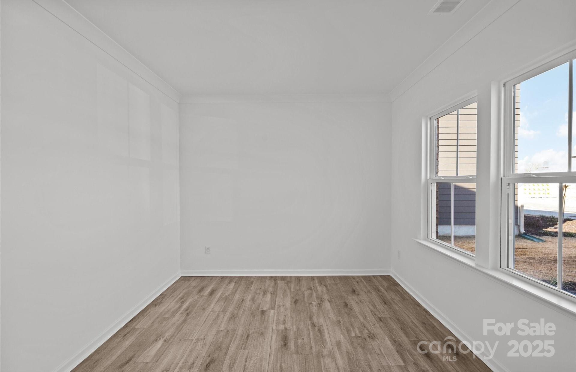 11416 Glasden Road, Unit 511 Charlotte, NC 28278 - Photo 2 of 13 wooden floor in an empty room with a window