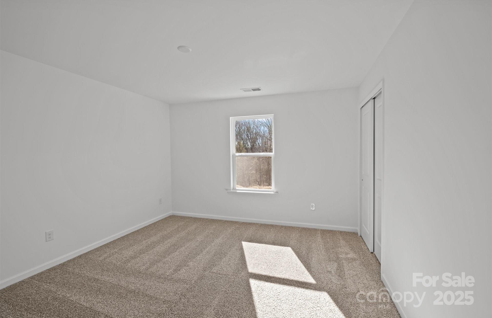 11416 Glasden Road, Unit 511 Charlotte, NC 28278 - Photo 10 of 13 an empty room with a window