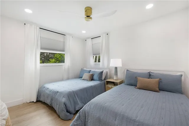 a bedroom with two beds and painted walls