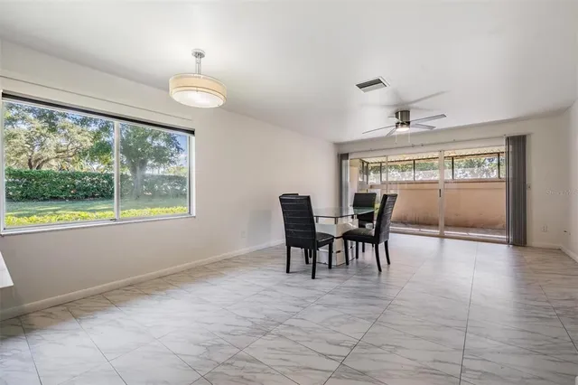 a view of a dining room with furniture window and outside view
