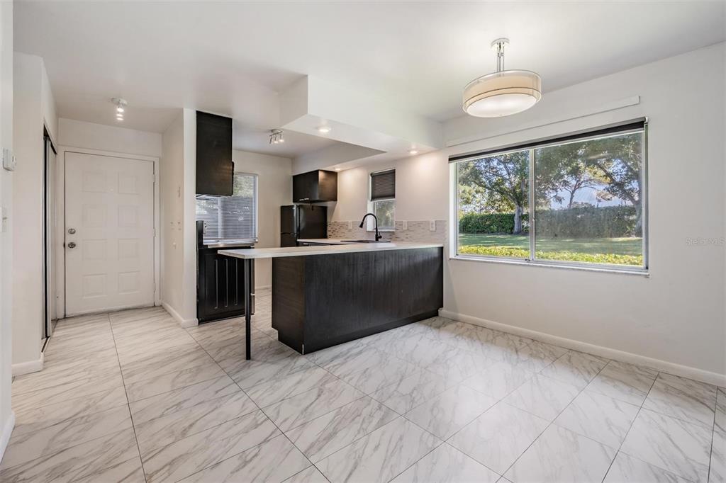 2292 Oak Neck Road, Unit A Clearwater, FL 33763 - Photo 14 of 37 a view of kitchen with kitchen island stainless steel appliances a sink stove and refrigerator
