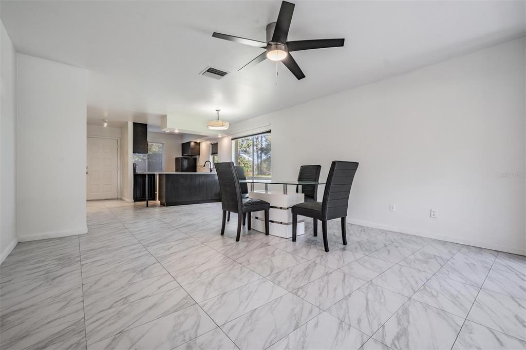 2292 Oak Neck Road, Unit A Clearwater, FL 33763 - Photo 16 of 37 a dining room with furniture and a refrigerator