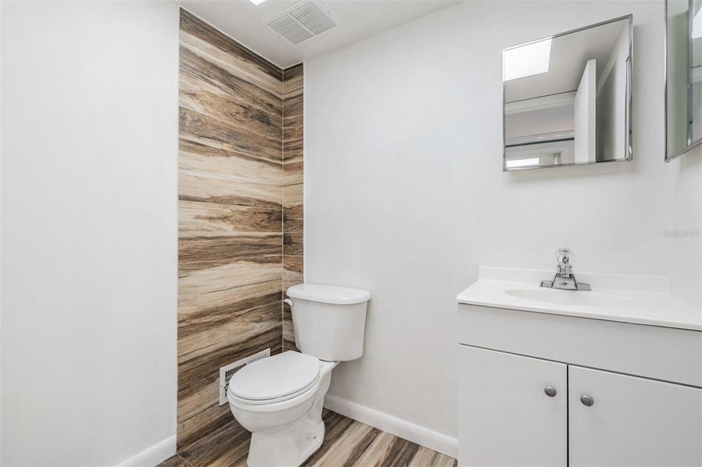 2292 Oak Neck Road, Unit A Clearwater, FL 33763 - Photo 18 of 37 a bathroom with a toilet sink and mirror