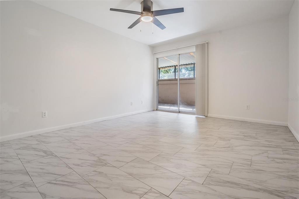 2292 Oak Neck Road, Unit A Clearwater, FL 33763 - Photo 19 of 37 an empty room with fan and windows