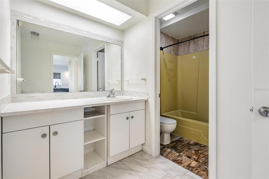 2292 Oak Neck Road, Unit A Clearwater, FL 33763 - Photo 23 of 37 a bathroom with a double vanity sink toilet and shower