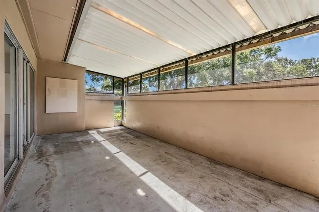 a view of an empty room with windows