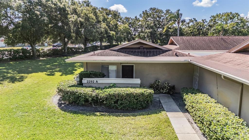 2292 Oak Neck Road, Unit A Clearwater, FL 33763 - Photo 30 of 37 a front view of a house with garden
