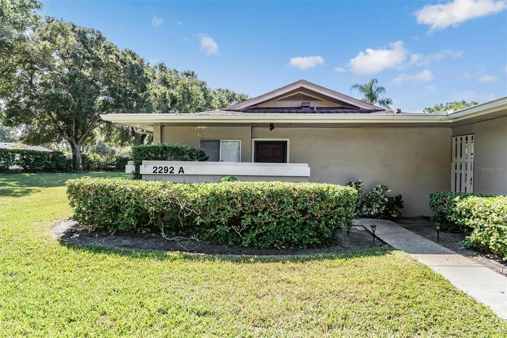 2292 Oak Neck Road, Unit A Clearwater, FL 33763 - Photo 3 of 37 a front view of a house with a yard