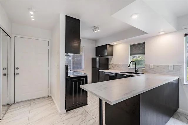 a kitchen with a refrigerator a sink and a stove