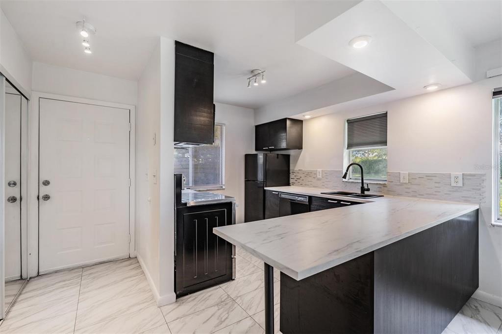 2292 Oak Neck Road, Unit A Clearwater, FL 33763 - Photo 5 of 37 a kitchen with a refrigerator a sink and a stove