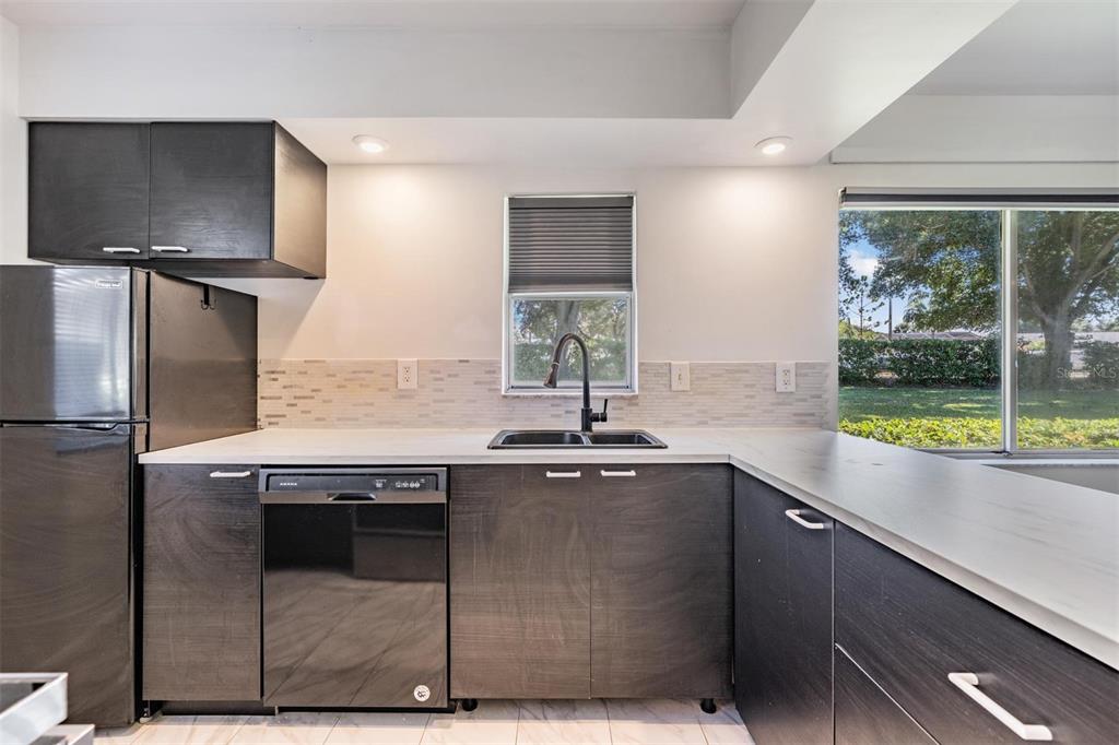 2292 Oak Neck Road, Unit A Clearwater, FL 33763 - Photo 7 of 37 a kitchen with stainless steel appliances granite countertop a sink and a refrigerator