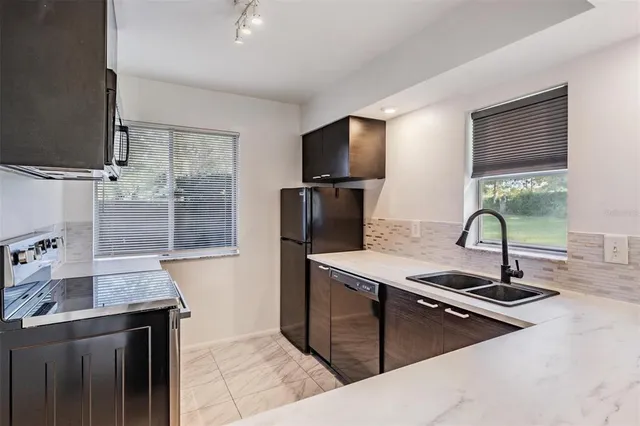 a kitchen with a sink and a refrigerator