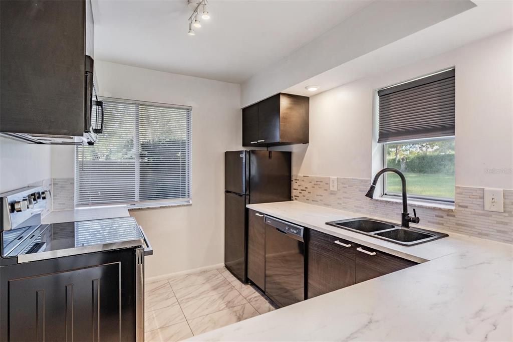 2292 Oak Neck Road, Unit A Clearwater, FL 33763 - Photo 8 of 37 a kitchen with a sink and a refrigerator
