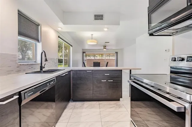 a kitchen with a sink and cabinets