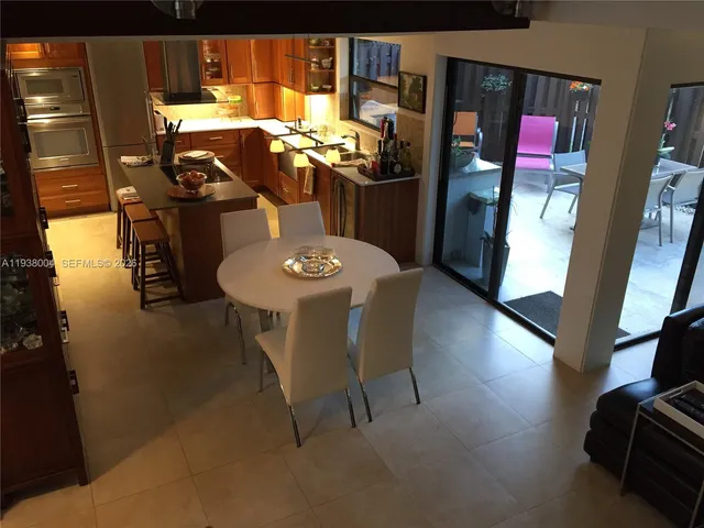 a view of a dining room with furniture and chandelier