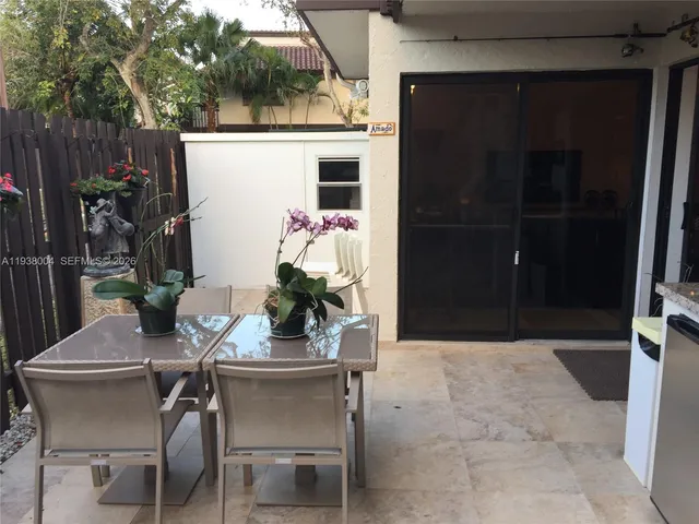 a backyard of a house with table and chairs