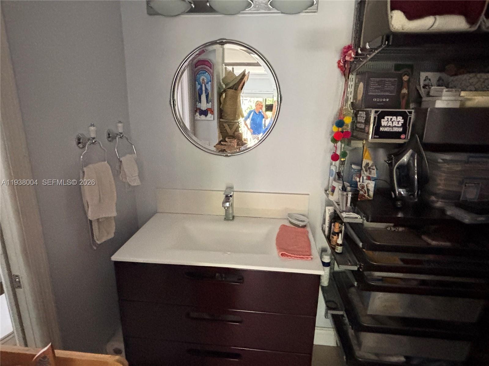 13253 Southwest 111th Terrace, Unit 3 Miami, FL 33186 - Photo 37 of 48 a bathroom with a sink and a mirror