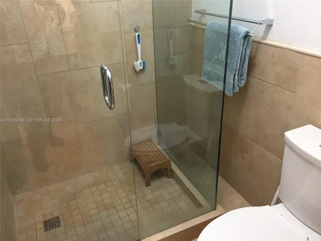 a bathroom with a toilet and a shower