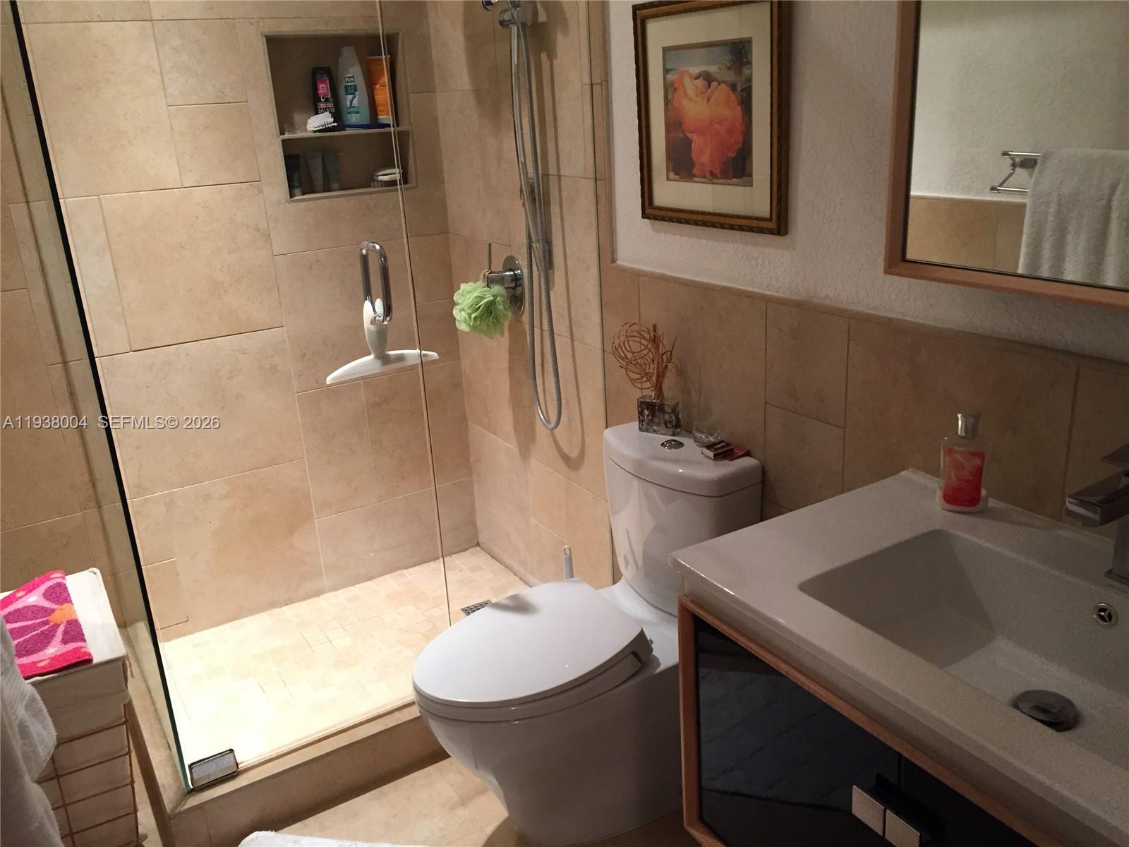 13253 Southwest 111th Terrace, Unit 3 Miami, FL 33186 - Photo 9 of 48 a bathroom with a sink and mirror with toilet