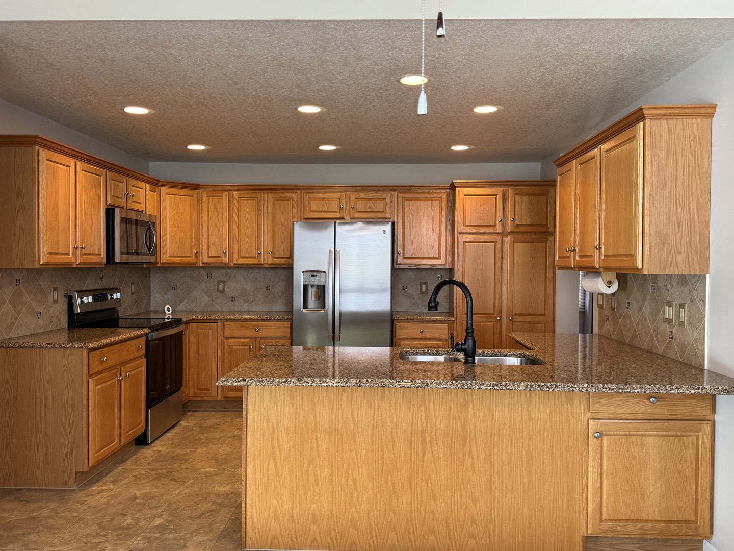 453 East Kay Street Herscher, IL 60941 - Photo 14 of 54 a kitchen with stainless steel appliances granite countertop a sink stove and refrigerator