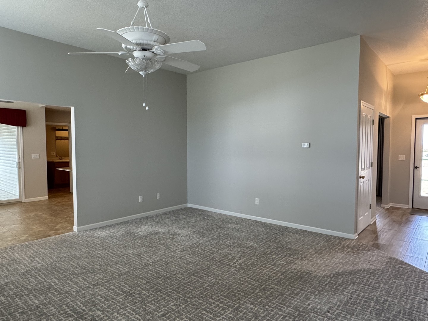 453 East Kay Street Herscher, IL 60941 - Photo 8 of 54 an empty room with a chandelier fan and windows