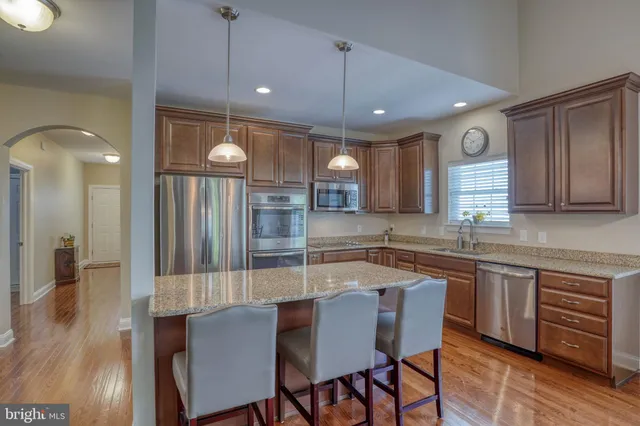 a large kitchen with a table and chairs