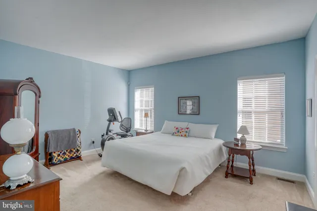 a bedroom with a bed and a dresser with mirror