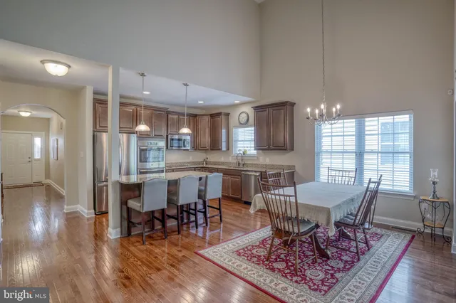 a view of a a dining room with furniture window and wooden floor